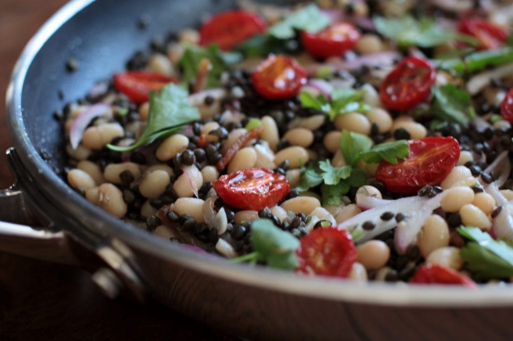 This warm bean bacon salad has a surprise ingredient....lentils! Lentils are packed with power nutrients and good for your soul. Add a hint of acidity with the oven roasted tomatoes and some freshness with the parsley. Voila! #lentilsalad #legumes #salad #pulses #warmsalad