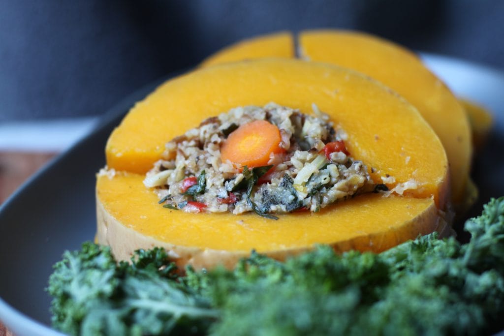 This entire stuffed and roasted butternut squash makes a great holiday side dish or main dish for vegans and vegetarians. Delicious and meant to mimic the famous turducken at your holiday table. #vegan #vegetarian #sides #veggiedukken