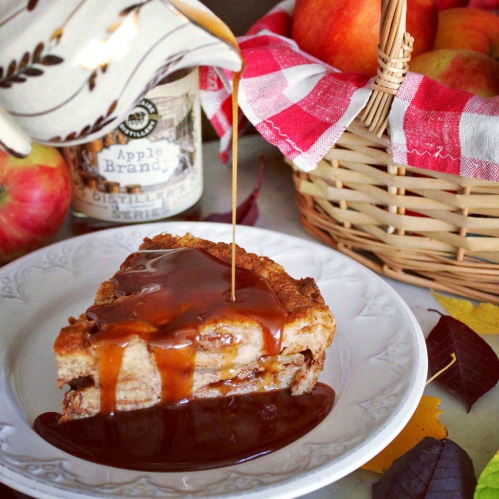 This Apple Brioche Bread Pudding is the perfect Autumn comfort food. Buttery Brioche bread and sweet apples are baked together with warming spices then served with a rich Apple Brandy Caramel Sauce. #breadpudding #briochebreadpudding #caramelsauce #falldessert #applebrandycaramel