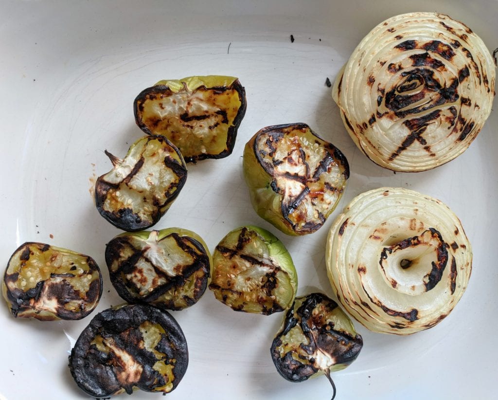 A platter of grilled tomatillos and onions