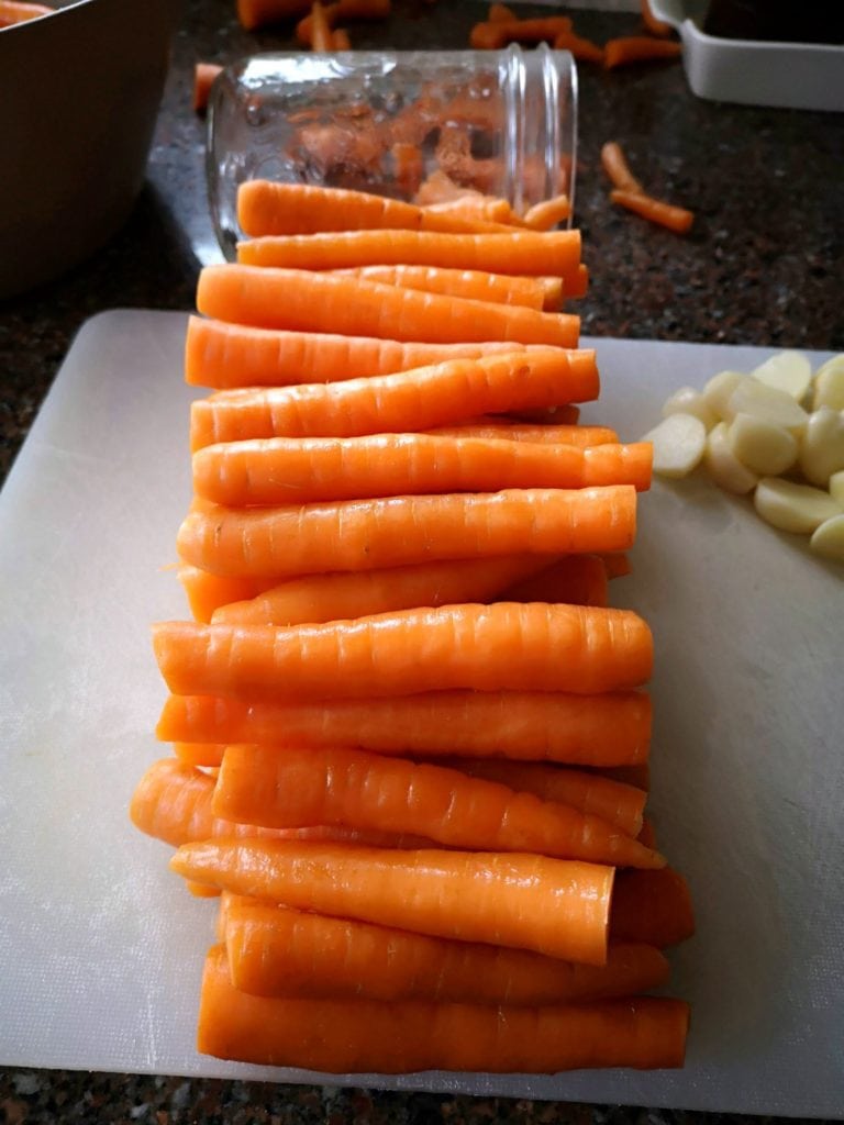 Pickled Carrots with Dill and Garlic - Bright carrots lined up and cut to size for pickling.