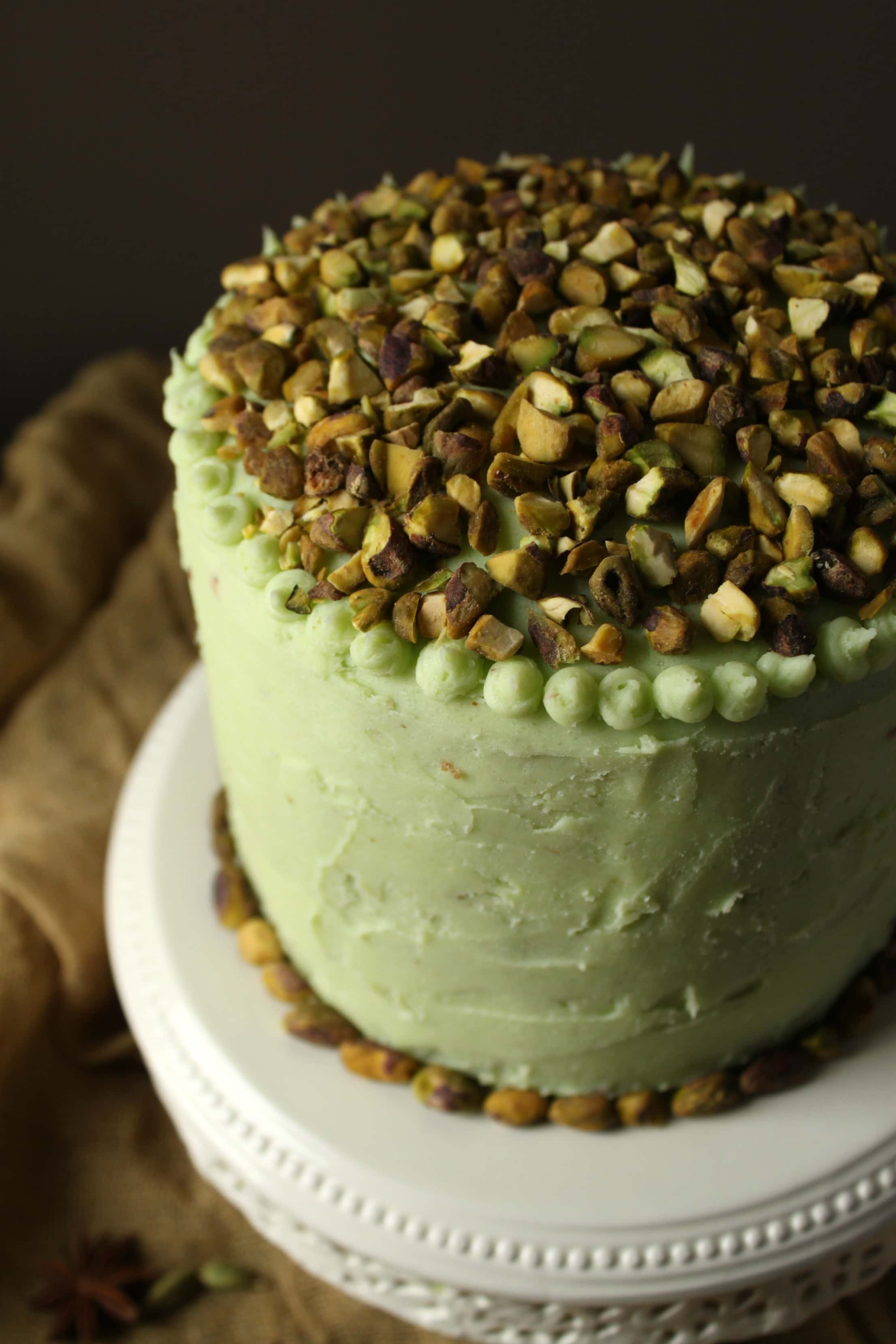 This Chai Layer Cake with Pistachio Buttercream is sweet little cake with a whole lot of attitude. Recipe makes three 6 inch layer cakes and enough pistachio buttercream to sandwich between layers, cover the cake, and all some decorative touches. #birthdaycake #chaicake #layercake #pistachiobutercream