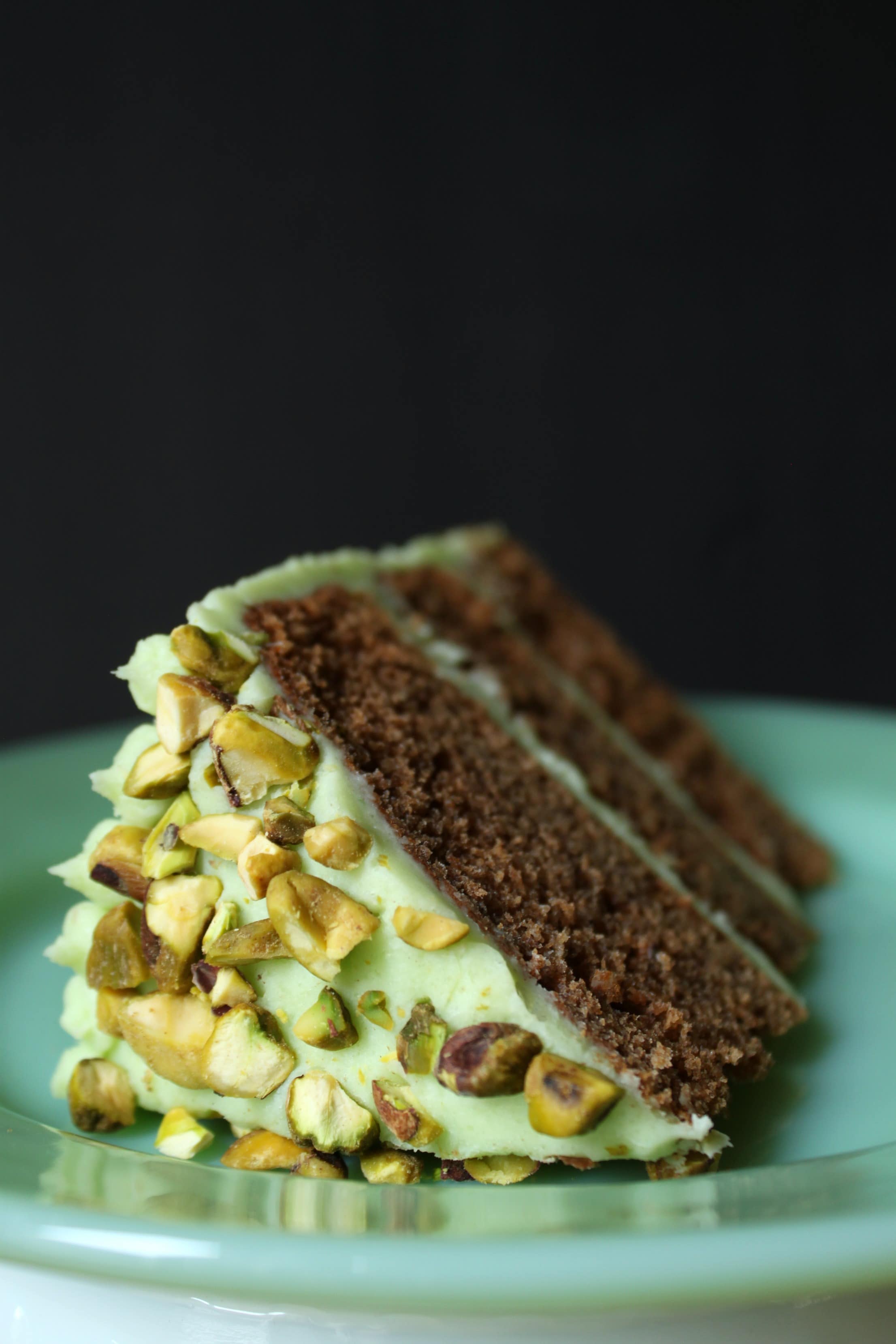 This Chai Layer Cake with Pistachio Buttercream is sweet little cake with a whole lot of attitude. Recipe makes three 6 inch layer cakes and enough pistachio buttercream to sandwich between layers, cover the cake, and all some decorative touches. #birthdaycake #chaicake #layercake #pistachiobutercream